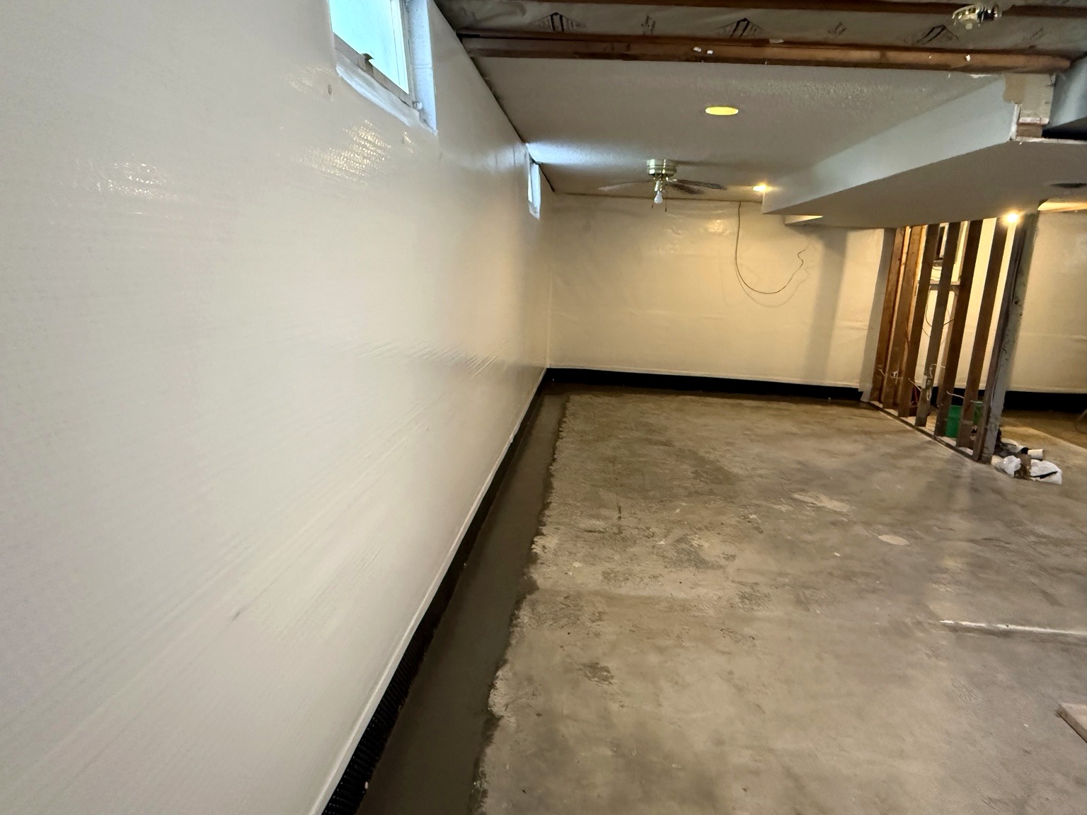 Wide view of basement perimeter drainage installation